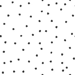Seamless abstract pattern of little black shabby dots or spots on white.