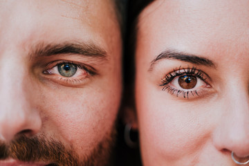 close up view of young happy couple together. Eyes close up. Love and family concept