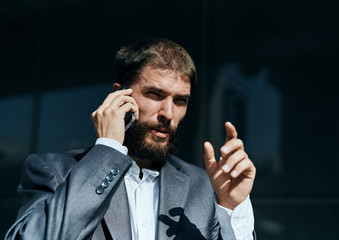 business man in a suit talking on the phone outdoors business manager executive