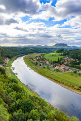 Obraz premium View from the bastei viewpoint of the Elbe river and the Rathen town in beautiful landscape scenery, Sandstone mountains, Saxon Switzerland National Park, Germany