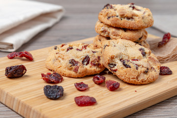 Cookies with cranberries on the kitchen table. Biscuit making concept.