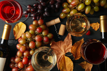 Composition with wine and grape on wooden background, top view