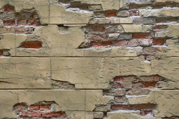 Destroyed Concrete and Brick wall with  faded and cracked paint