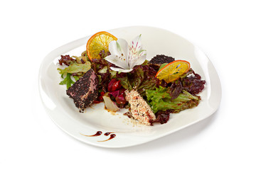 Salad with grilled beef slices and lettuce isolated on white