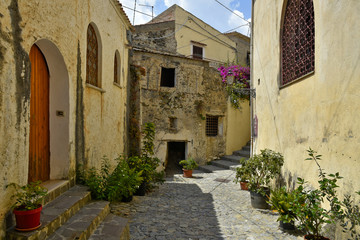 Fototapeta na wymiar A narrow street among the old houses of Scalea, a rural village in the Calabria region.