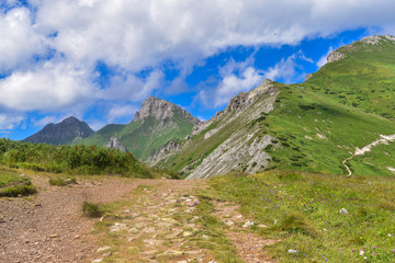 Fototapeta premium The mountains, forests and lakes in the Tatra Mountains in Slovakia. Clouds reflected in the water. Breathtaking views in mountains. Mountains in Slovakia (Bielanskie Tatry, Tatry Bielskie)