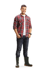 Fototapeta premium Full length portrait of a male gardener in boots