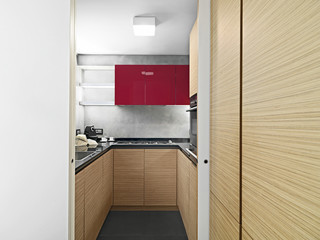 modern kitchen interior with red wall units and wooden cabinets