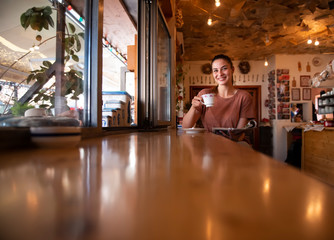 Obraz na płótnie Canvas drinking, cafe, coffee, beverage, female, conversation, girl, drink, woman, adult, tea, cup, pretty, smiling, reading, read, magazine, beautiful, smile, cafeteria, lifestyle, restaurant, relax, happy,