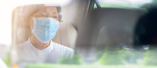 Asian elderly woman wear face mask in car or taxi prevent from covid-19 pandemic illness crisis....