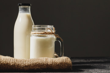 Bottle and glass of milk, front view