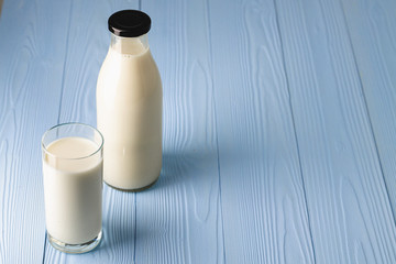 Bottle and glass of milk, front view