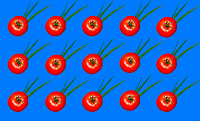 Red tomato with green onion on blue.