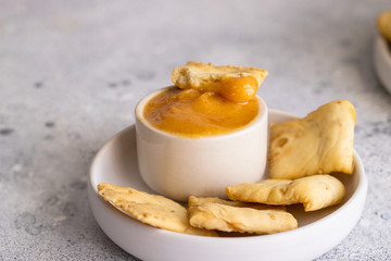 Almogrote, famous La Gomera cheese paste, in white ceramic bowl  with crusty crackers on background. Its popular appetizer served in many restaurants in Canary Islands