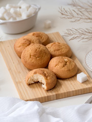 homemade biscuit cookies on a bamboo board, a cup of coffee, refined sugar - still life in light colors