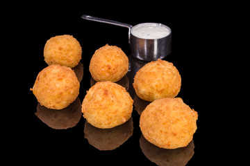 Delicious balls from yellow cheese and sauce with reflection