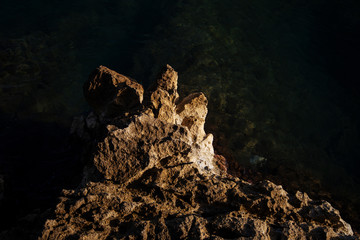 Beautiful sky and rocky coast on Spain. A photograph of the sea surface and rocky shore. Sea wave...