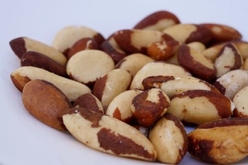 Brazil nuts (castanhas do Pará) on white plate.
