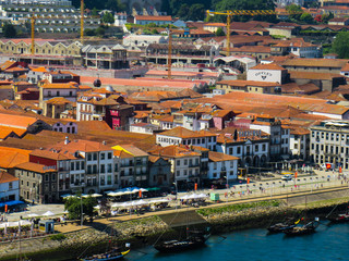 Vila Nova de Gaia, Porto, Portugal - July 18, 2019: Restaurants and Porto wine warehouses at the riverfront promenade of Douro.