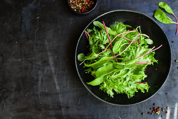 Healthy salad leaves mix salad micro greens, serving portion size
natural juicy snack. food background keto or paleo diet raw