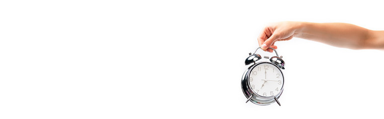 panoramic crop of woman holding vintage alarm clock isolated on white