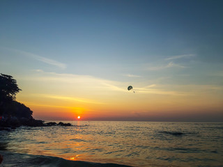 Parachute flight on a warm evening at sunset in Thailand.