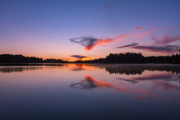 The sunset on the lake, Valday, base of rest "Vatsy", Russia. Lilac landscape