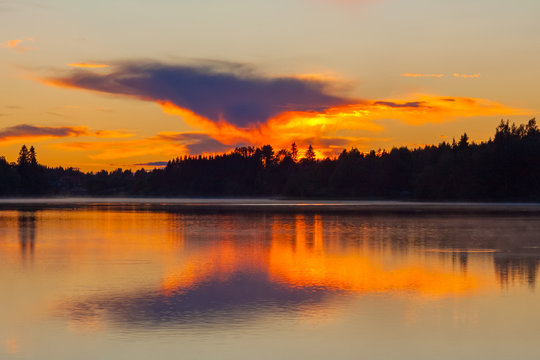 The sunset on the lake, Valday, base of rest "Vatsy", Russia. Bright orange landscape