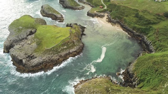 Cliffs in Asturias. Coastal landscape in Cue, beach of Llanes. Spain. Aerial Drone Footage