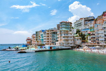 Embankment in the Utes city, Crimea. Colorful houses are close to each other, beautiful scenery