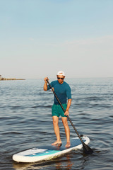 Man is training on a SUP board.