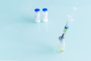medical syringe and vials with vaccine, medicine