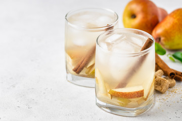 Sparkling pear cinnamon  cocktail in glasses. Space for text.