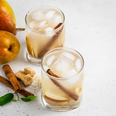 Autumn pear cider cocktail in glasses. Space for text.