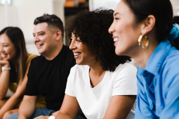 Close up of smiling coworkers sitting in a row