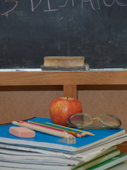 back to school with colored pencils on yellow background and coronavirus mask