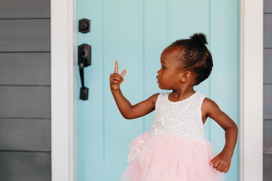 Girl in tutu pointing her finger while standing outdoors