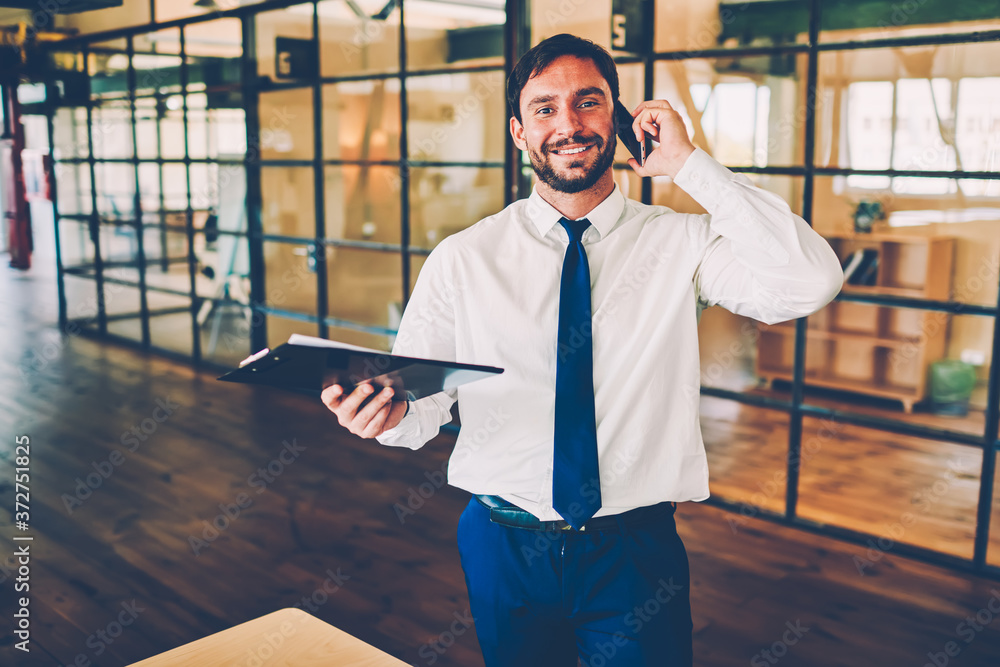 Aufkleber half-length portrait of busy entrepreneur talking on phone while colleague discussing ideas, prosper
