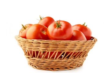 Tomatoes in basket isolated on white background