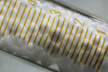 White spherical ammonium nitrate in a measuring test tube.