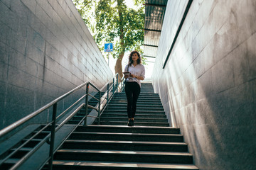 Woman in a white shirt with a notebook in her hands