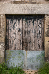 Weathered And Derelict Doors, With Roman Numerals Overhead, Braga, Portugal