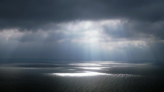 Scenic seascape. Beautiful rays of sun breaking through the clouds over The Black sea. 4K
