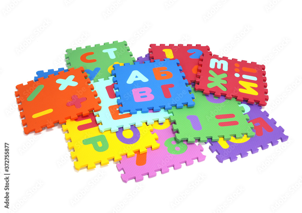 Fototapete puzzle mat - multicolored soft elements letters and numbers on a white background