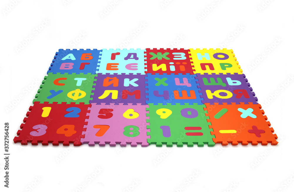 Fototapete puzzle mat - multicolored soft elements letters and numbers on a white background