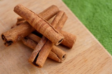 Cinnamon sticks on wooden background.
