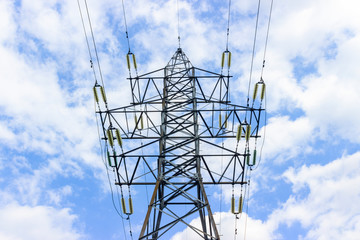 High voltage transmission lines over blue cloudy sky background. electricity pylons, cables and fencing on the tower. technologies related to Electricity, concept, Close up