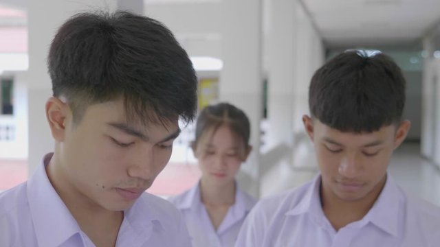 Slow motion of Asian students in a white uniform are  wearing white masks during the Coronavirus 2019 (Covid-19) epidemic.