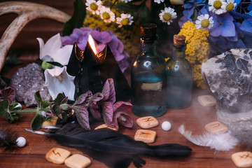 Fototapeta premium witchcraft concept with potions, herbs and occult equipment