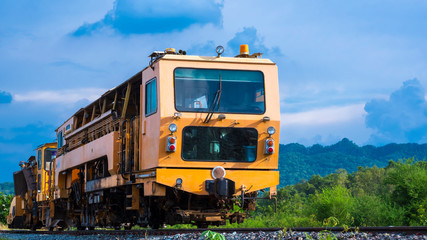 Fototapeta na wymiar Low angle view of the old orange diesel locomotive on railway against blue sky in natural background